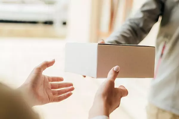 close-up-hands-getting-box-min
